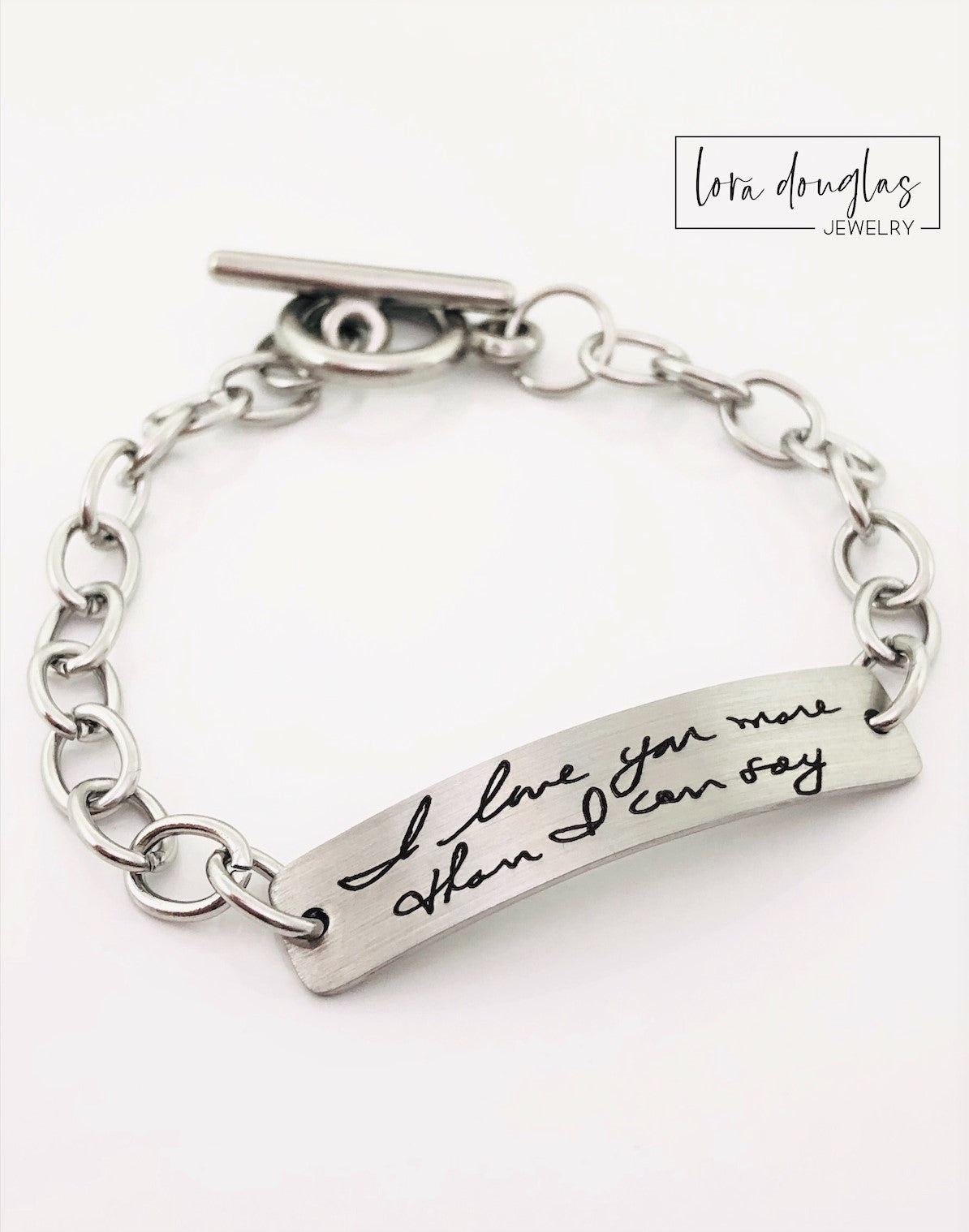 A stainless steel bracelet with engraved handwriting
