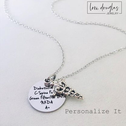 A stainless steel medical alert necklace with a round pendant displaying medical information and a 24-inch chain.