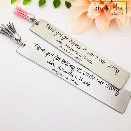 Two stainless steel bookmarks with personalized engraving, 'Thank you for helping us write our story. Love, {Name 1} & {Name 2}' and a date