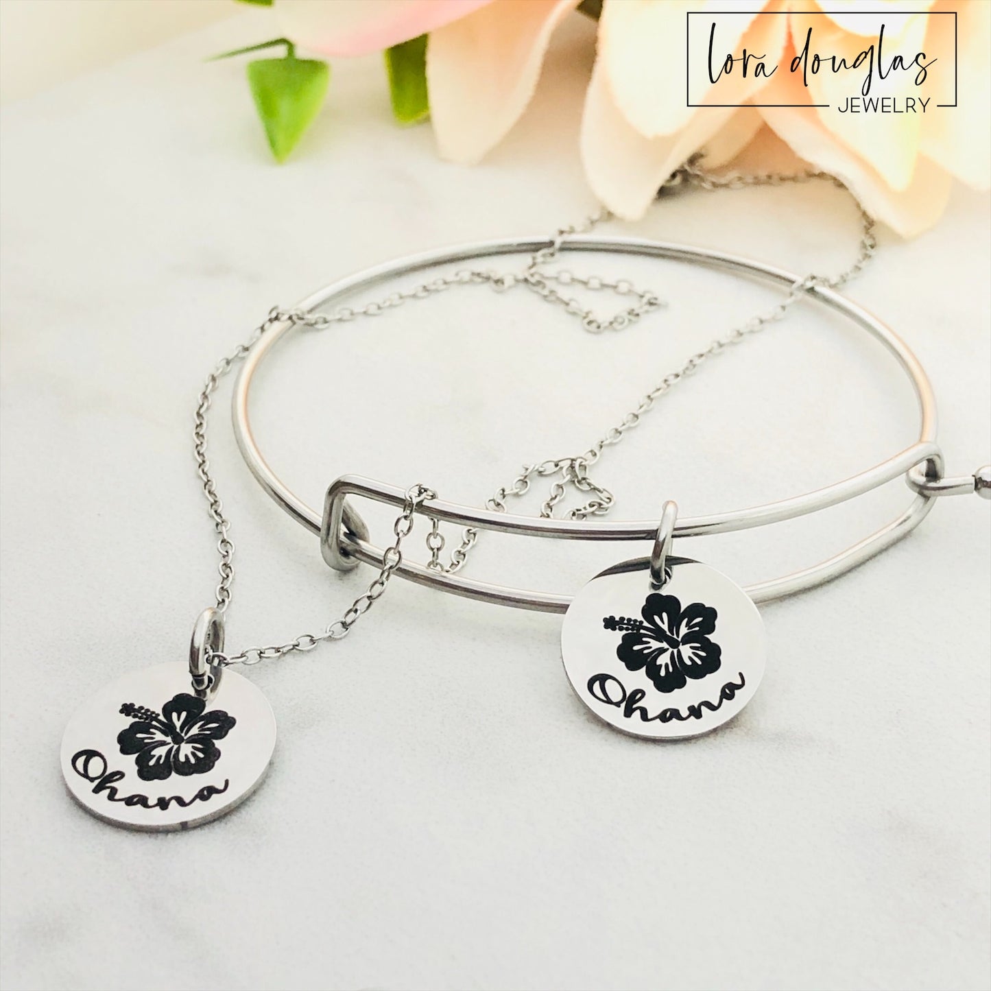 A collection of jewelry items with Ohana, Family means no one gets left behind or forgotten. available in bracelet, necklace or charm options