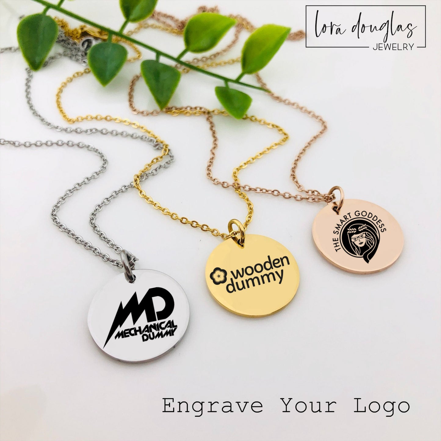 Three custom jewelry charms with engraved logos on a disc-shaped pendant, attached to different types of jewelry including a necklace and a bracelet, with the option to engrave your logo.