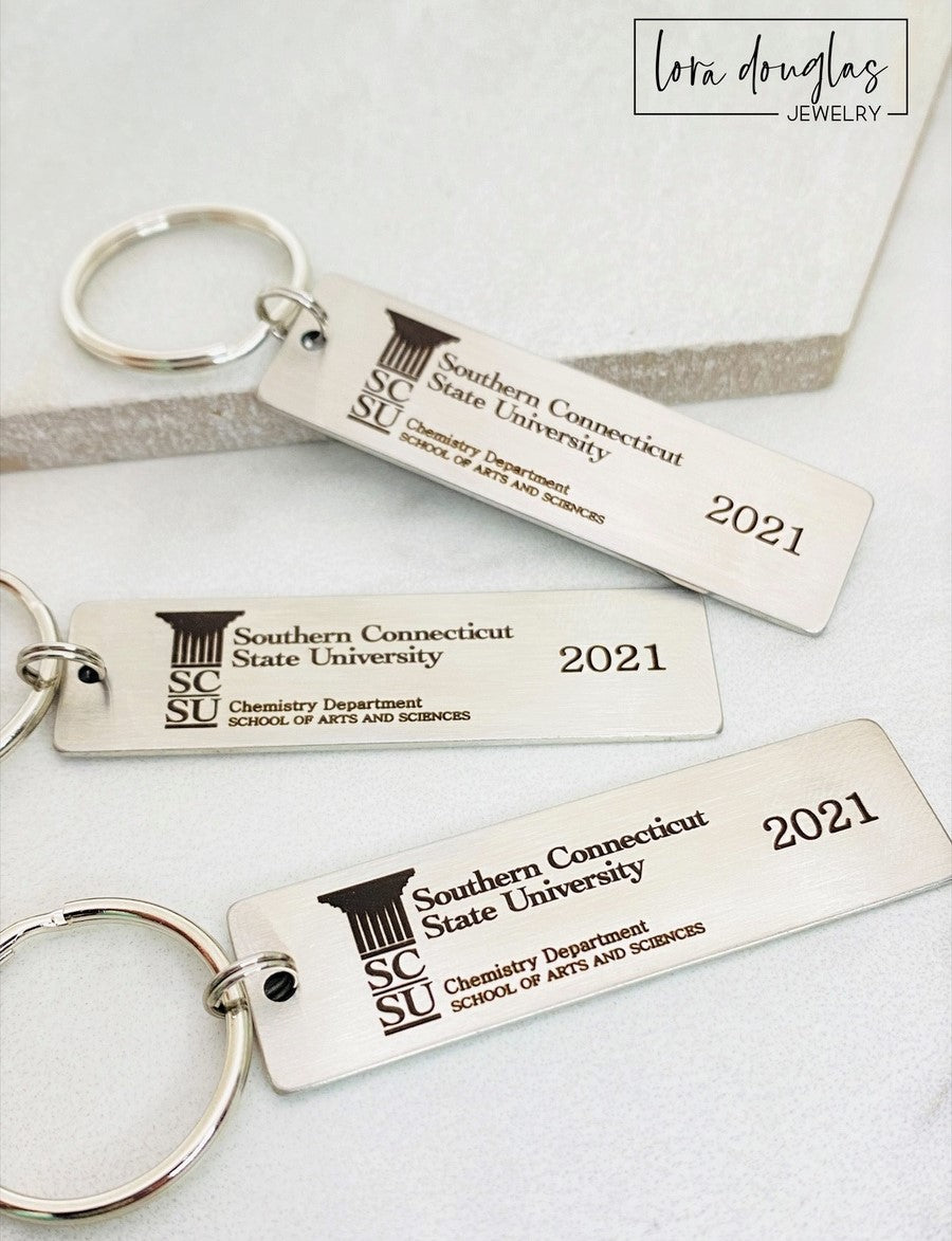 A silver stainless steel keychain with a custom logo engraving