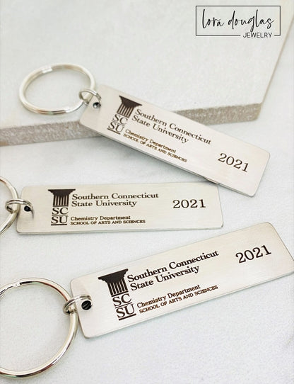 A silver stainless steel keychain with a custom logo engraving