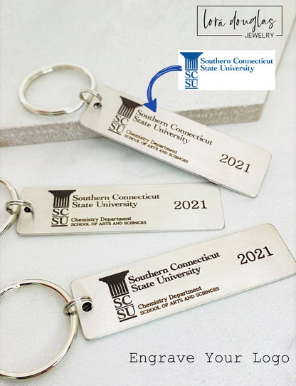 A silver stainless steel keychain with a custom logo engraving