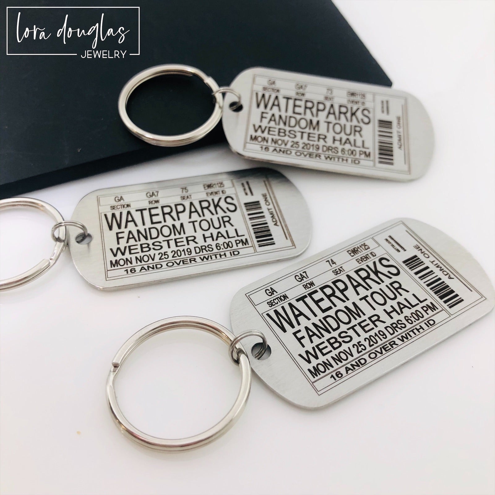 Capture your favorite concert memories with this playful dog tag style keychain, custom engraved to mimic your ticket stub from any band, concert, or event.