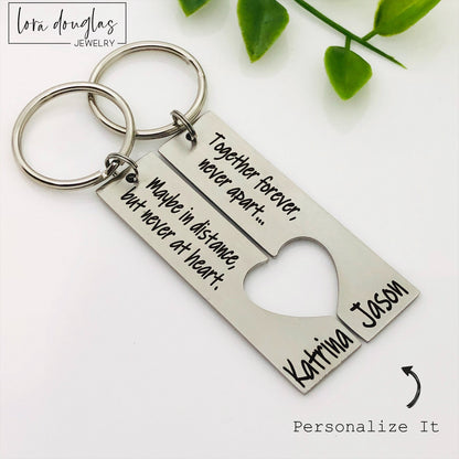 A stainless steel heart-shaped keychain with engraved text 'Together Forever Never Apart Maybe in Distance but Never at Heart' The keychain is silver-colored and has a personalized engraving.