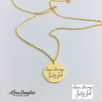 gold engraved necklaces displayed on a white background. necklace has a personalized handwritten message engraved on a disc charm, with varying text colors and styles.