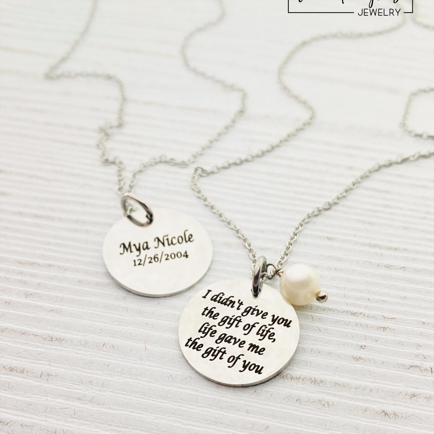 Two silver pendants with engraved with 'I DIDN'T GIVE YOU THE GIFT OF LIFE, LIFE GAVE ME THE GIFT OF YOU' 