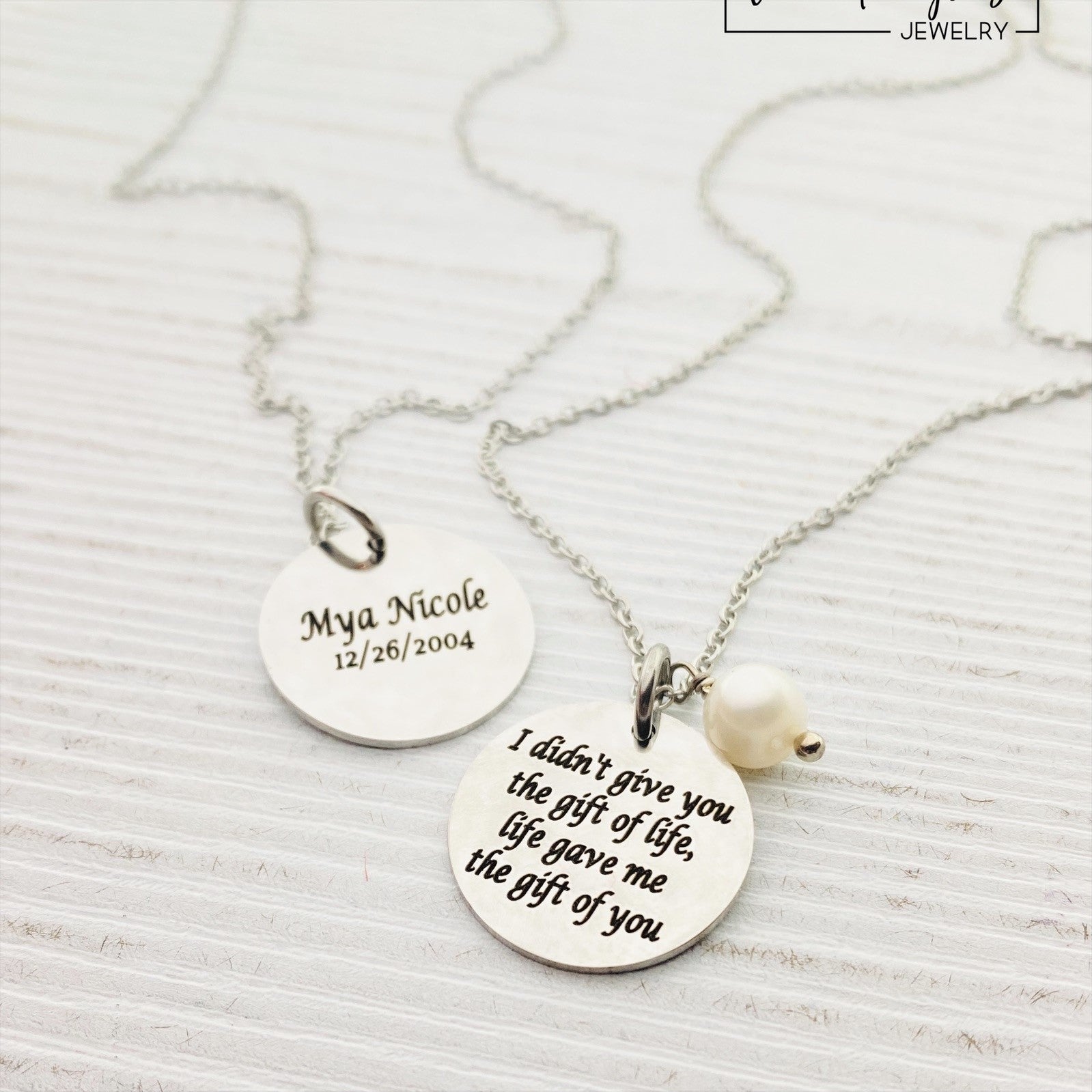 Two silver pendants with engraved with 'I DIDN'T GIVE YOU THE GIFT OF LIFE, LIFE GAVE ME THE GIFT OF YOU' 