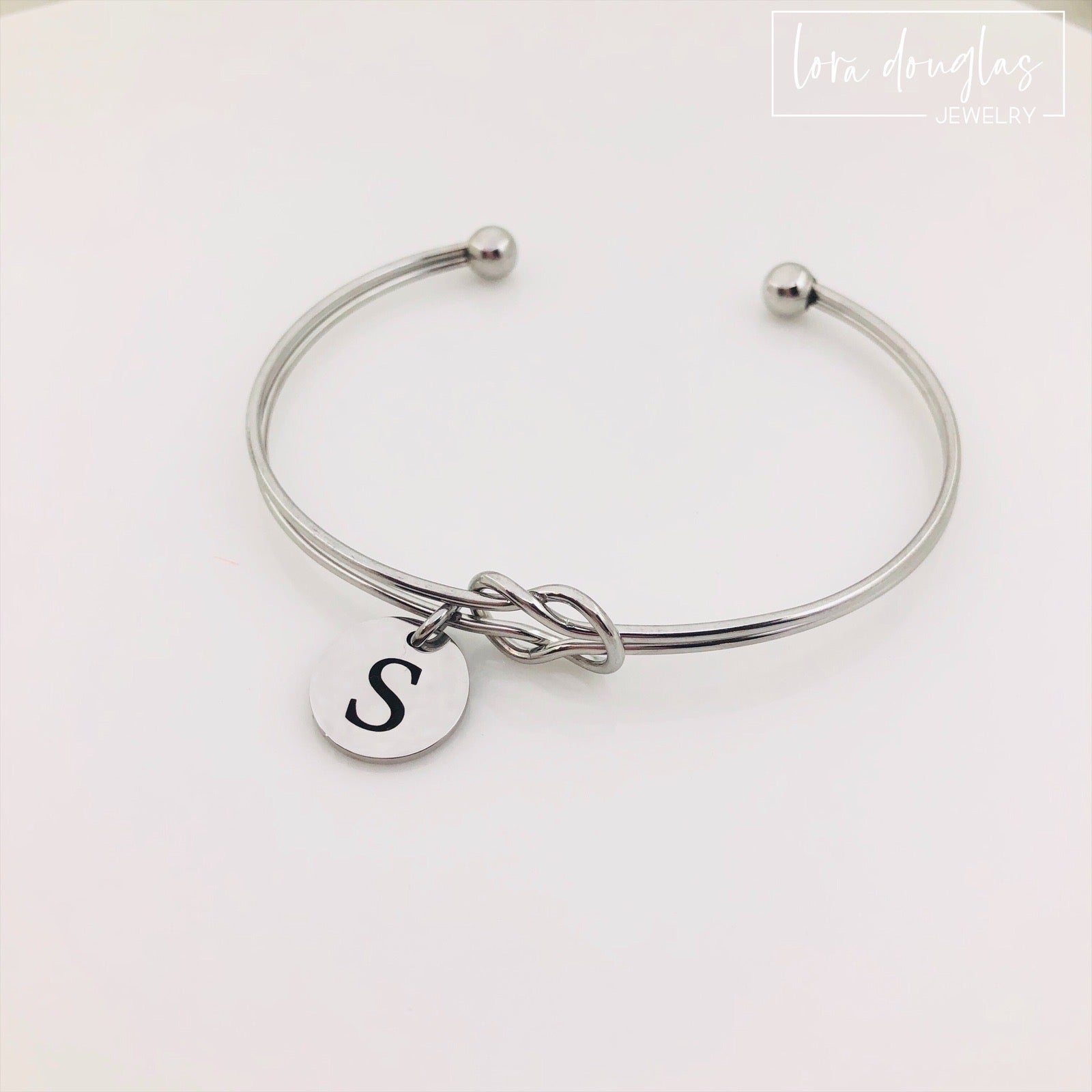 silver stainless steel knot bracelet with initial charm. bridesmaid gift