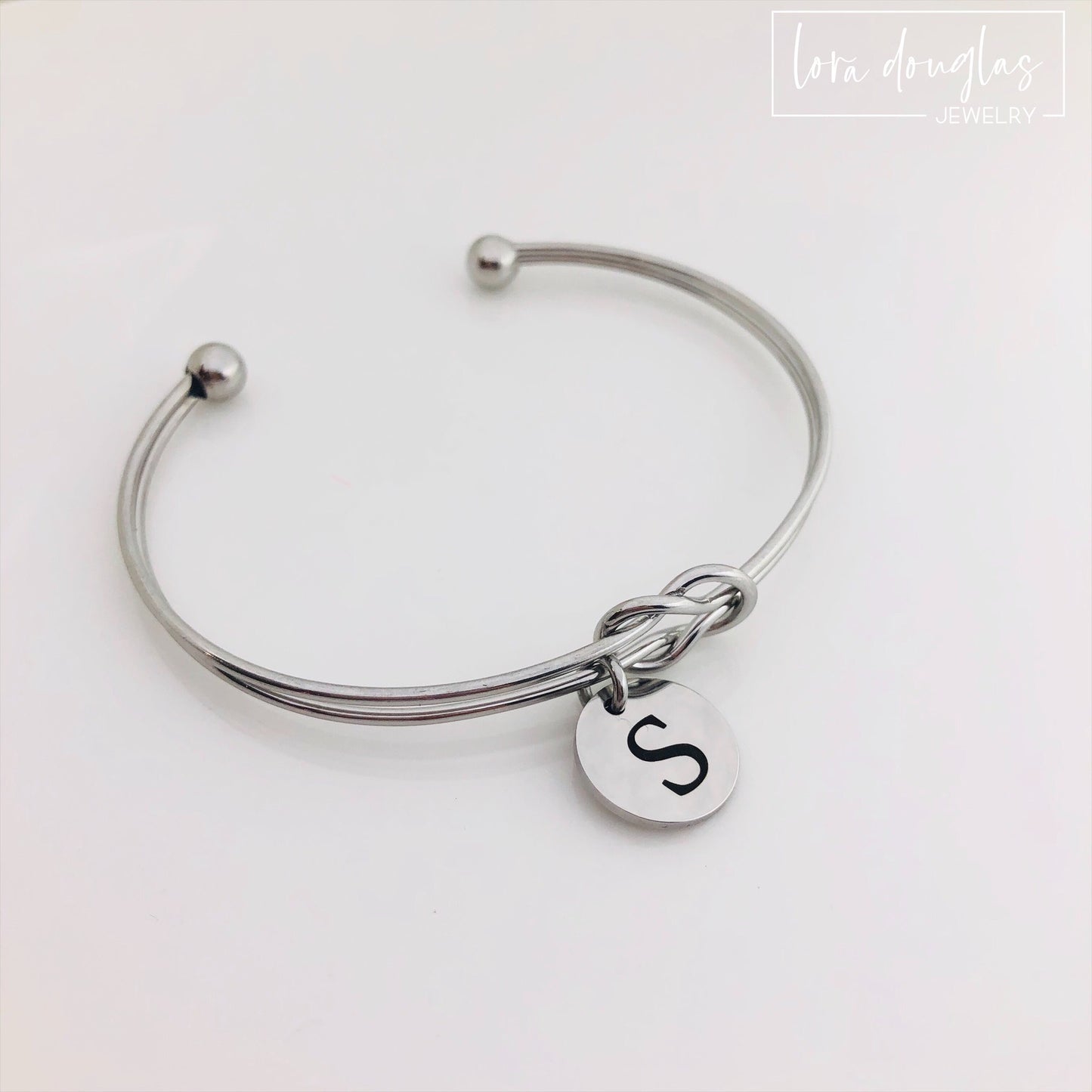 silver stainless steel knot bracelet with initial charm. bridesmaid gift