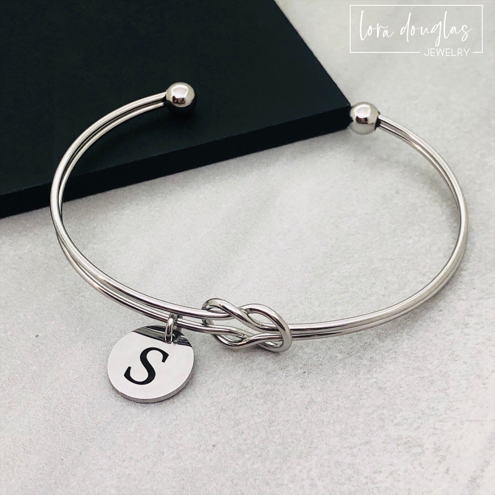 silver stainless steel knot bracelet with initial charm. bridesmaid gift
