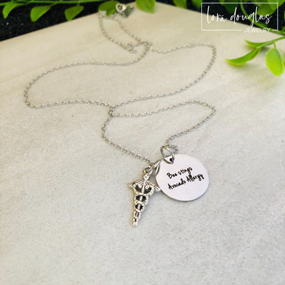 A stainless steel medical alert necklace with a round pendant displaying medical information and a 24-inch chain.