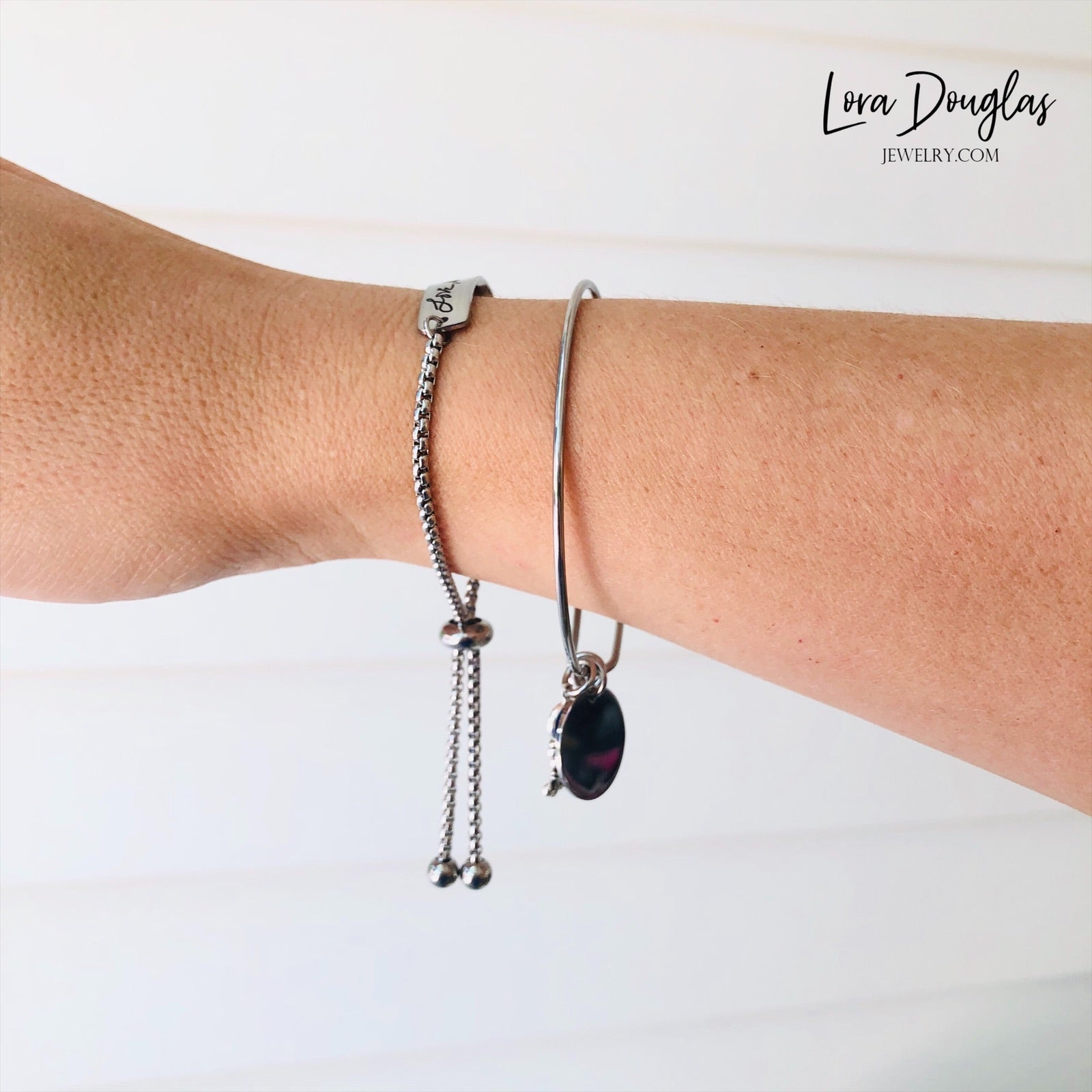 Adjustable stainless steel bracelet engraved with a handwritten message.
