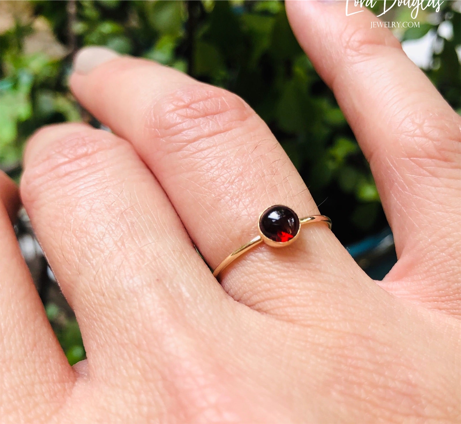 Gold-filled garnet solitaire ring, size 6, with a flat band and a polished finish, displayed on a plain background.