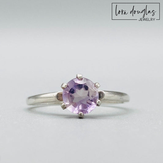 Pink amethyst ring featuring a 6mm lavender pink gemstone set in sterling silver, shown as a finished US size 6.5 solitaire ring for shoppers looking for delicate amethyst and natural gemstone jewelry.
