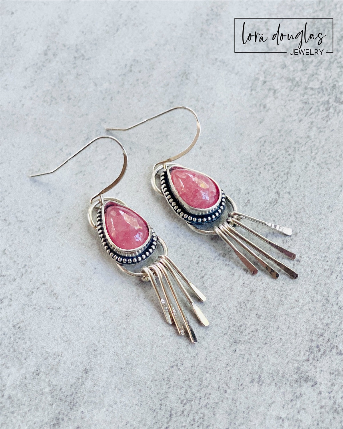 Pink gemstone dangle earrings featuring natural rhodochrosite teardrops with handcrafted 925 sterling silver fringe, designed as lightweight statement earrings for shoppers who love colorful artisan jewelry.
