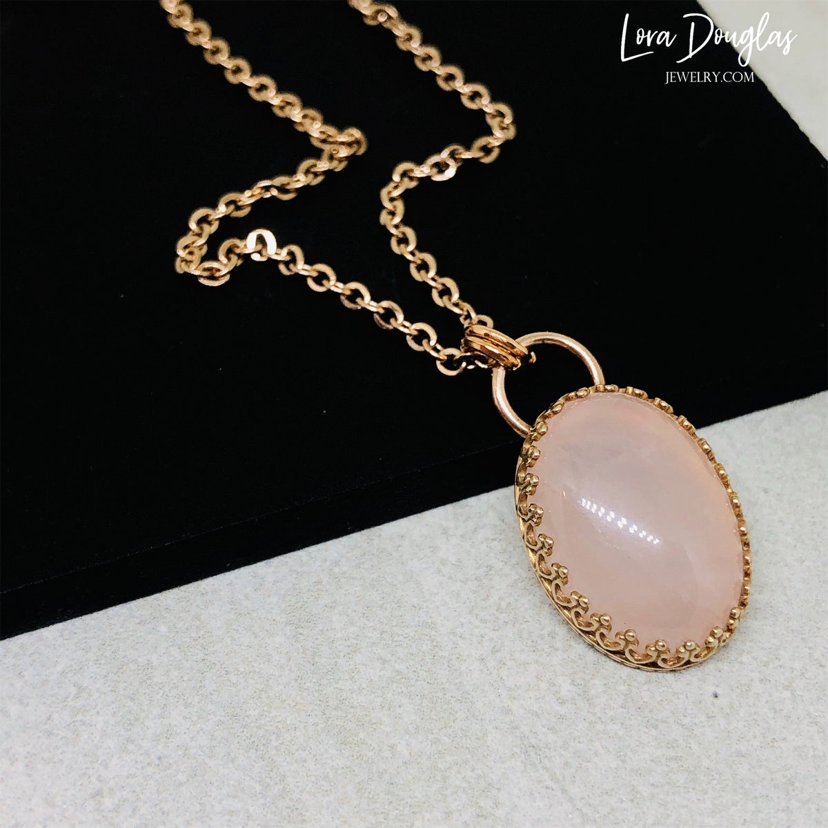 Pink gemstone necklace featuring natural rose quartz in a 24mm x 14mm bronze pendant setting with an 18 inch stainless steel chain, a meaningful choice for romantic jewelry and natural stone gifts.
