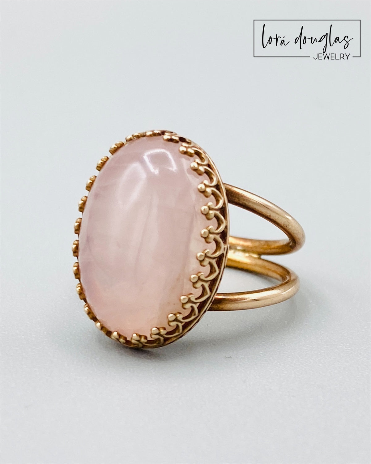 Pink gemstone statement ring featuring natural rose quartz in an 18mm x 13mm stone with a bronze ring and setting, shown in US size 6 for shoppers seeking romantic jewelry or a natural stone gift.
