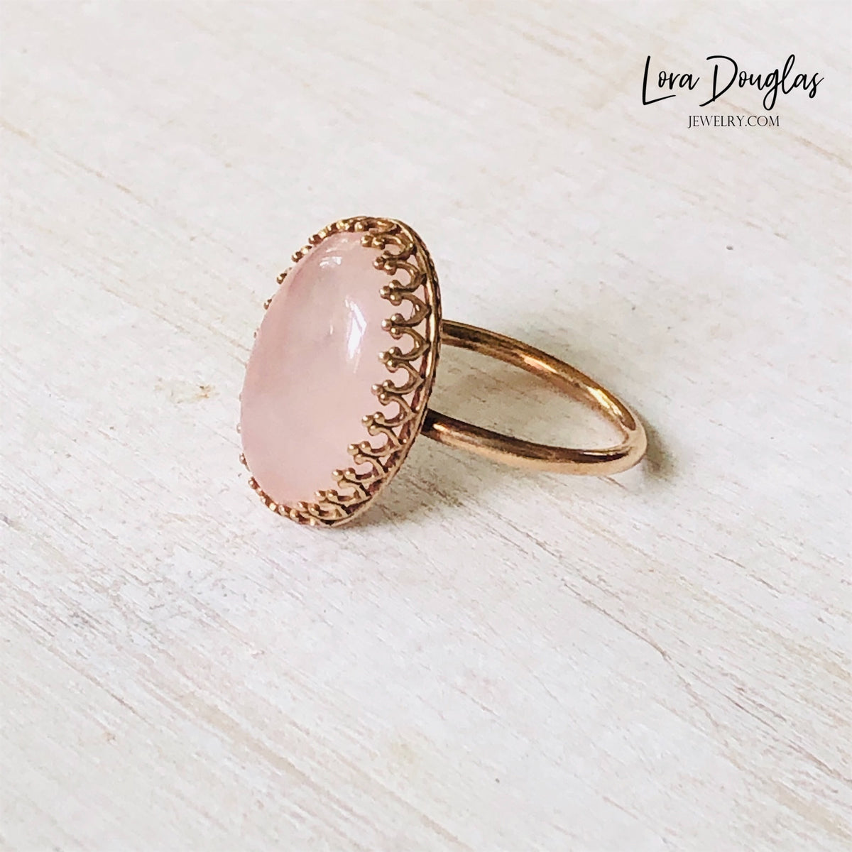 Pink gemstone statement ring featuring natural rose quartz in an 18mm x 13mm stone with a bronze ring and setting, shown in US size 7.5 for shoppers seeking romantic jewelry or a natural stone gift.

