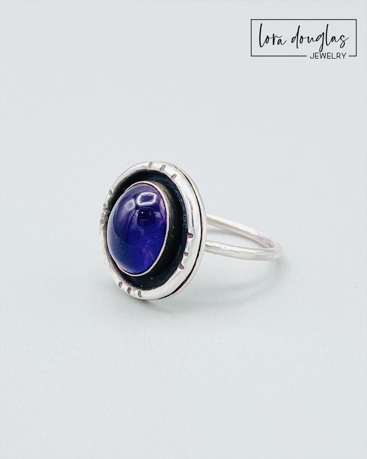 Purple gemstone statement ring featuring natural amethyst in a sterling silver shadow box setting, shown in US size 7.5 for shoppers seeking handcrafted silver jewelry and distinctive natural stone rings.
