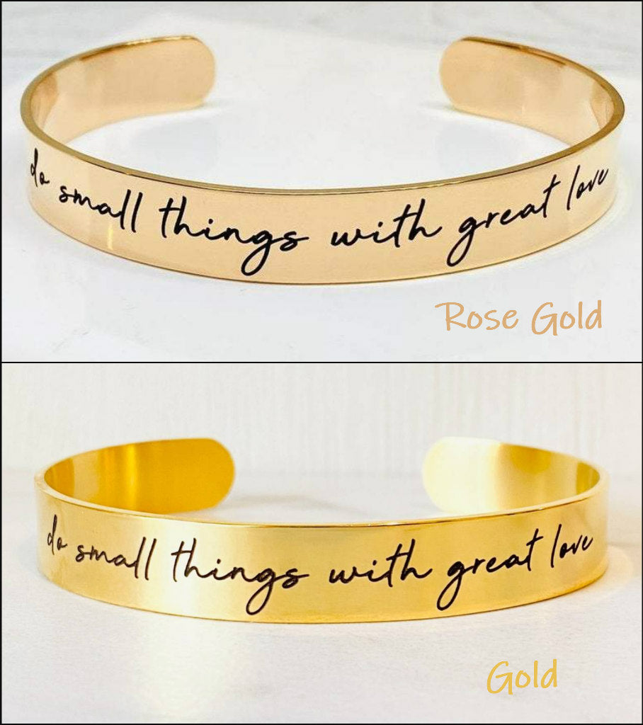 Two stainless steel cuff bracelets, one in rose gold and one in gold color, each with an engraved message 'Do small things with great love'.