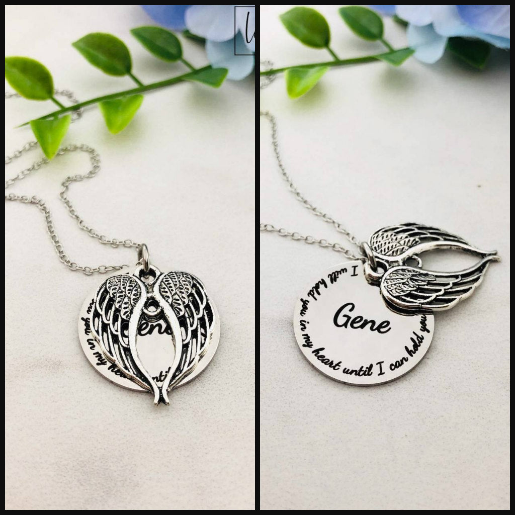 Two stainless steel memorial necklaces with swing lockets. One has a silver finish and the other has a gold tone. Angel wing charm necklace.
