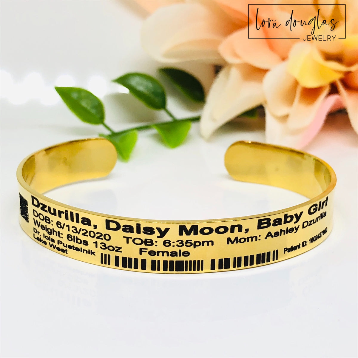 gold personalized birth bracelet designed to resemble a newborn hospital identification band, custom engraved with baby name, date of birth, hospital information and other birth details selected by the customer.
