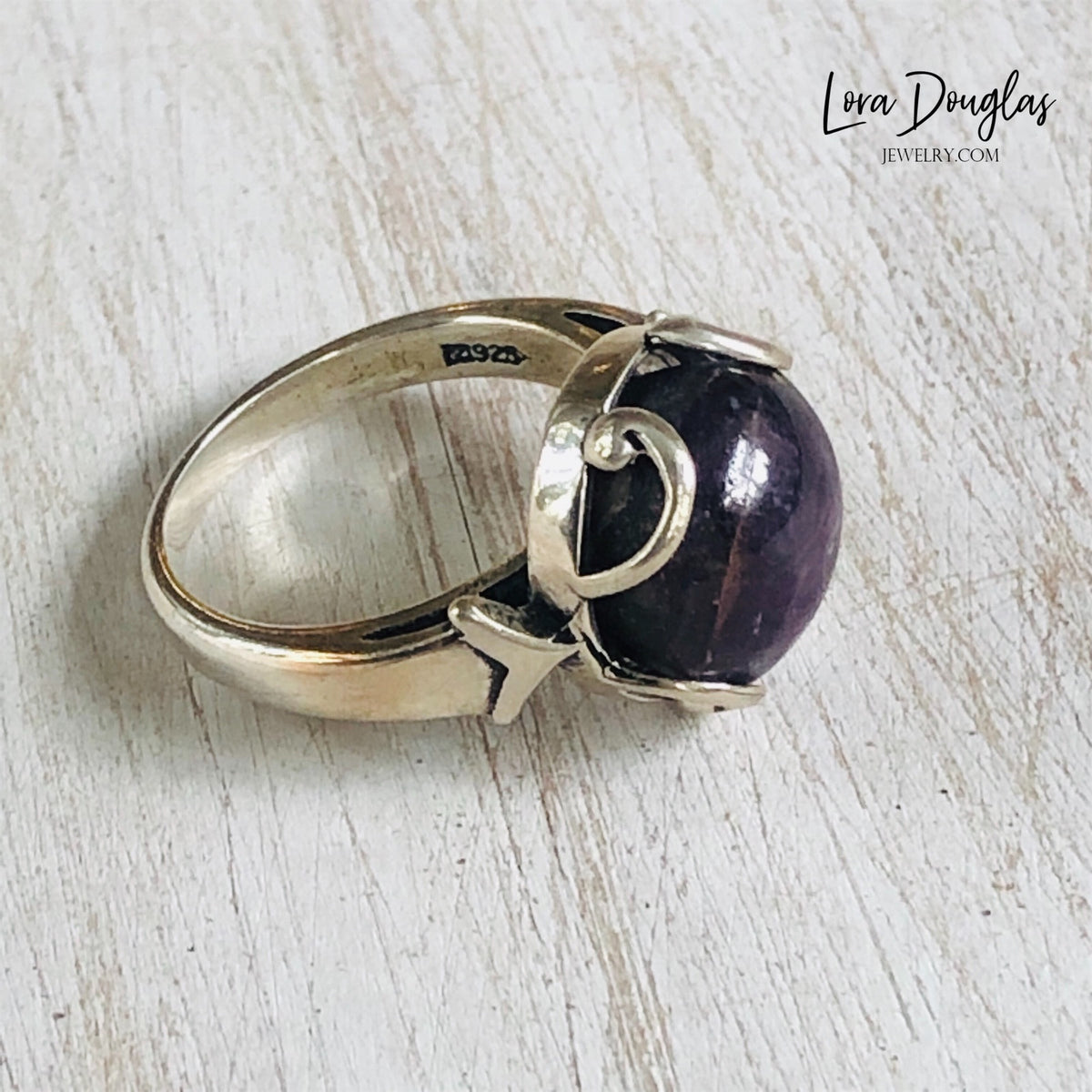 Size 7 Purple India Ruby ring made with genuine 925 sterling silver and a natural 12mm gemstone, highlighting the distinctive purple coloring and substantial profile of this one of a kind natural stone ring.
