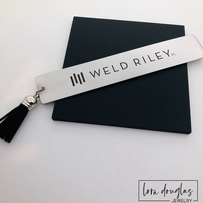 Stainless steel bookmark personalized with a custom company logo using permanent laser engraving. Elegant corporate gift for employee awards, customer appreciation, conference giveaways, nonprofit fundraising, and business marketing.