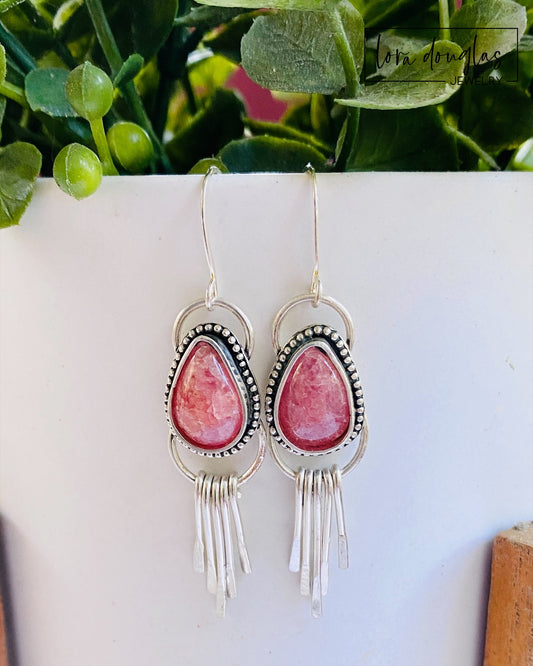 Sterling silver fringe earrings featuring pink rhodochrosite teardrop stones and dangling silver details, handcrafted as lightweight 2 inch earrings for shoppers looking for distinctive natural gemstone jewelry.
