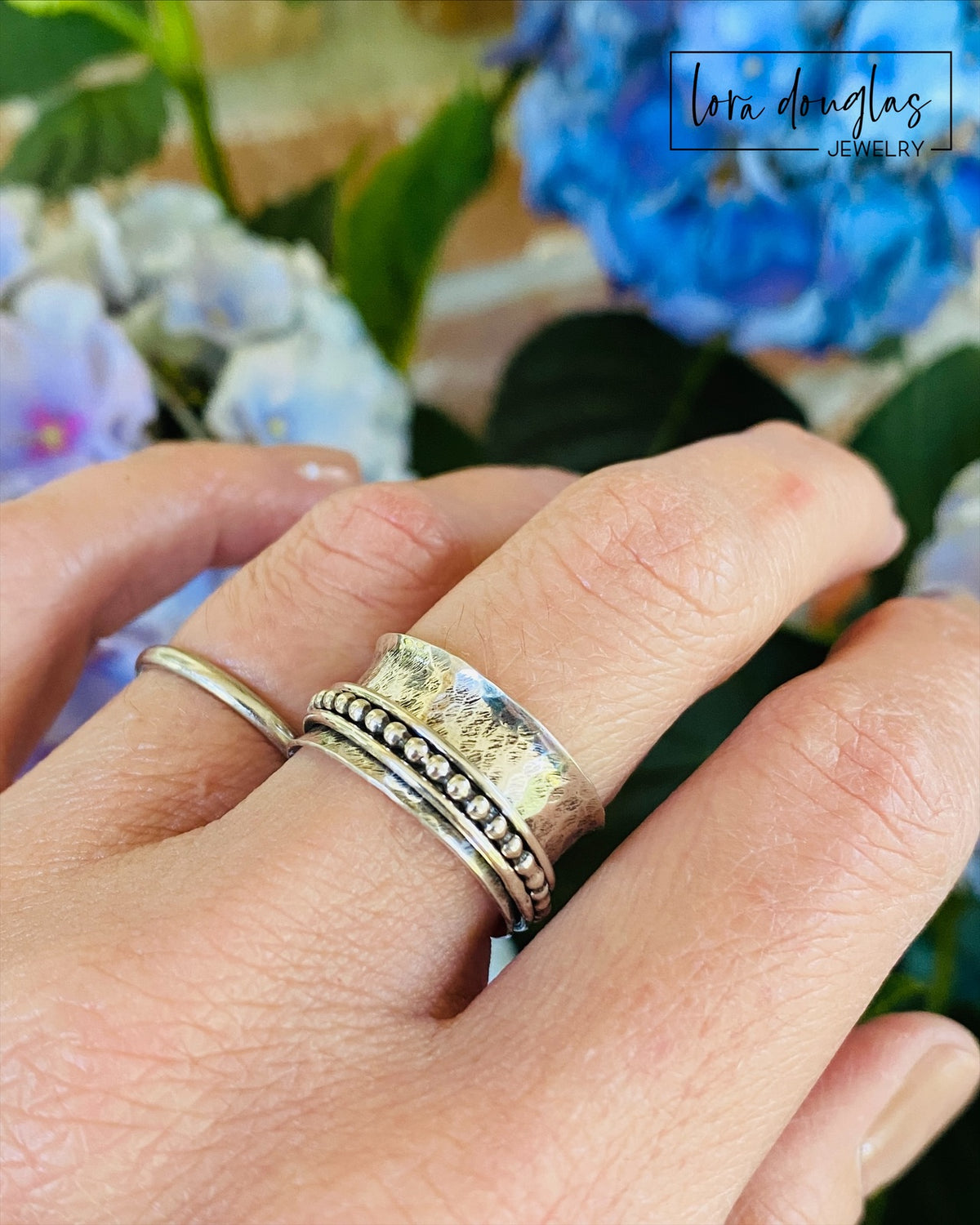 Sterling silver meditation ring with three movable spinner components and a 10.5mm wide central band, finished in US size 8.5 for anyone searching for a fidget ring, worry ring or interactive jewelry gift.
