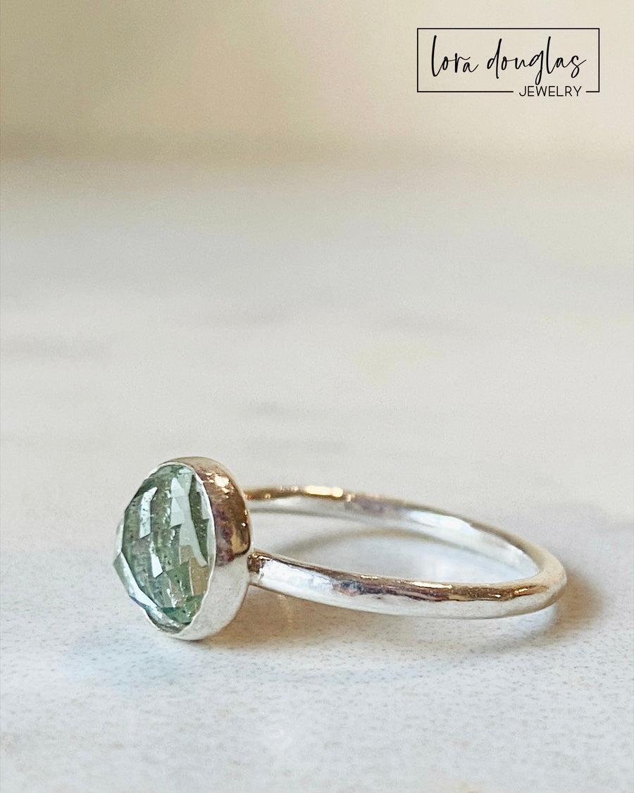 Sterling silver prasiolite ring featuring a softly colored 8mm green amethyst gemstone with a faceted rose cut, shown in finished US size 6 for lovers of green quartz and natural gemstone jewelry.
