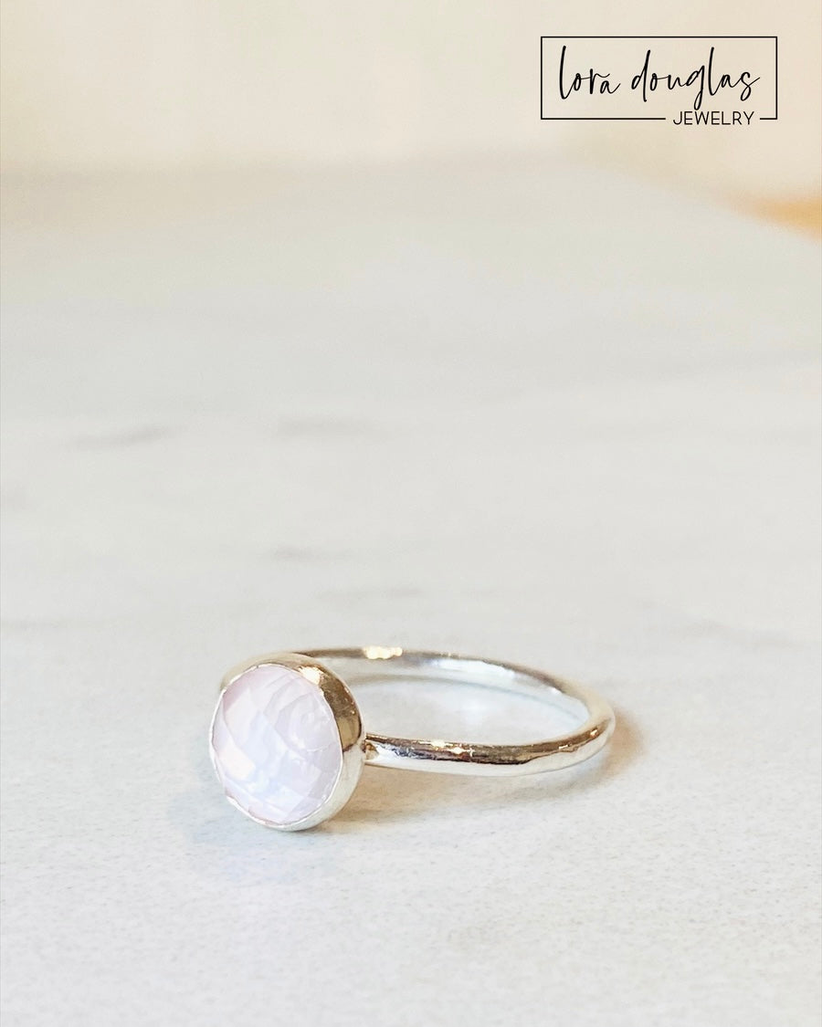 Sterling silver rose quartz ring featuring an 8mm rose cut faceted gemstone with soft pink coloring, shown in US size 7.5 as a simple solitaire design for a romantic gift or meaningful natural stone jewelry.
