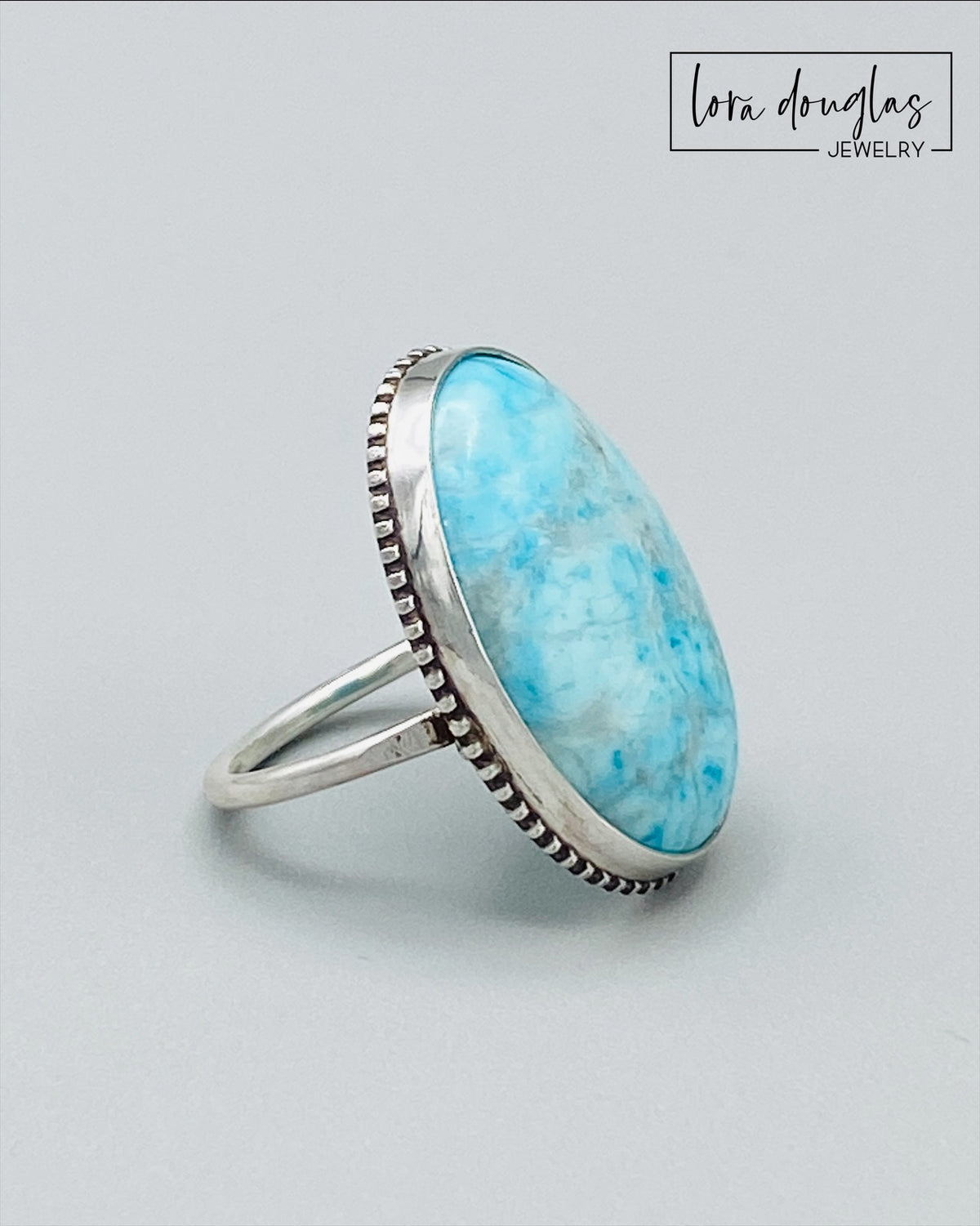 Sterling silver turquoise statement ring featuring a natural 26mm x 19mm gemstone, with the large blue stone as the focal point of this finished size 7 ring for lovers of distinctive turquoise jewelry.
