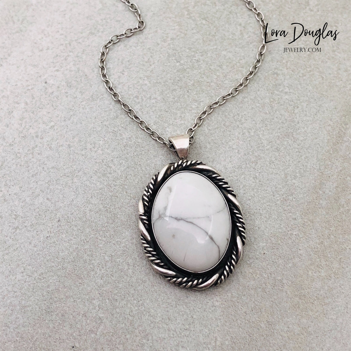 White gemstone necklace featuring natural howlite with distinctive gray veining in a handcrafted sterling silver pendant. Unique one of a kind artisan jewelry for collectors of natural stone and silver jewelry.