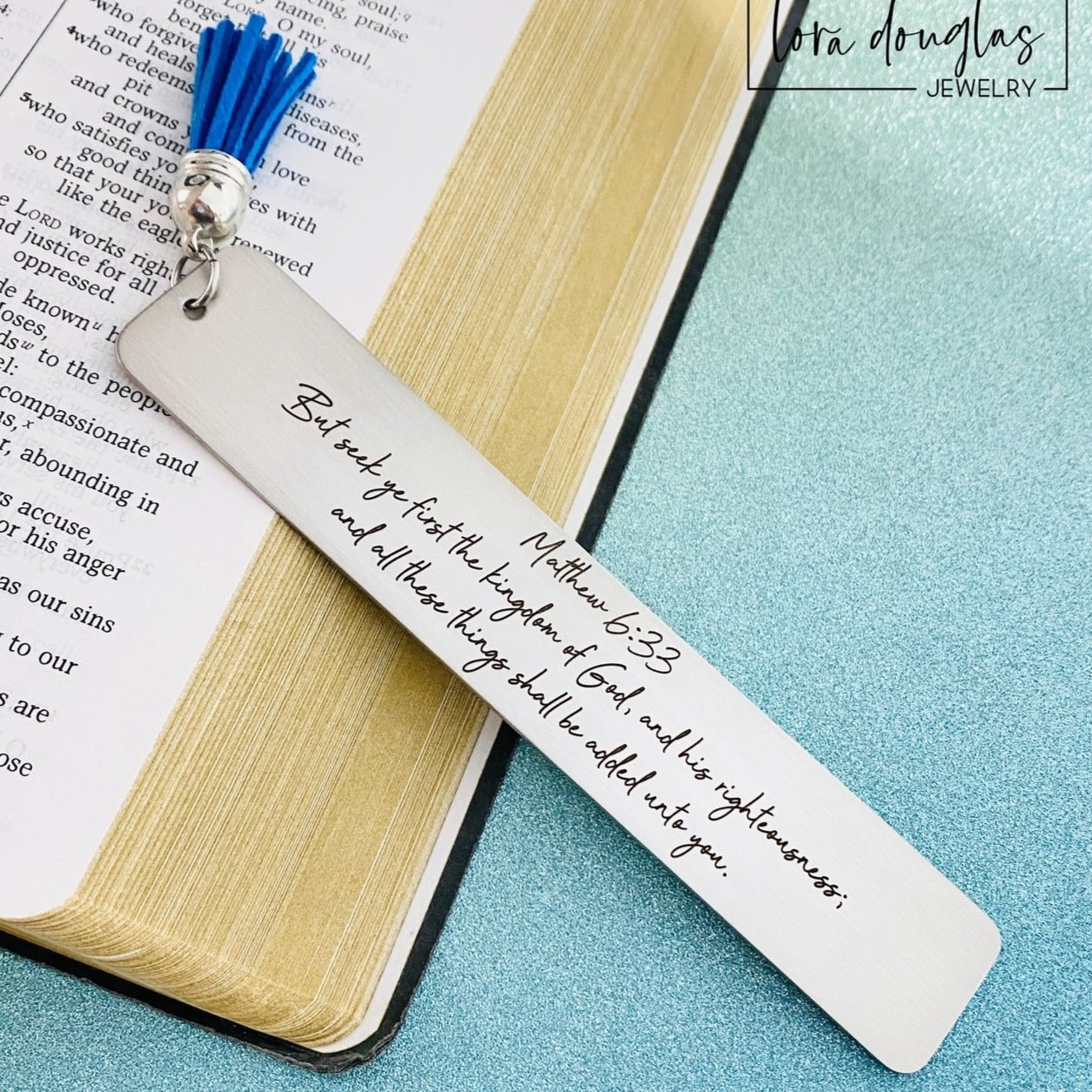 christian scripture bookmark in brushed stainless steel engraved with custom Bible verse and personalized text, laser engraved religious bookmark with tassel shown as meaningful Bible study gift