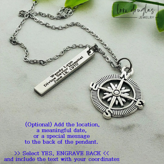 A silver compass necklace with a stainless steel pendant with personalized latitude and longitude coordinates