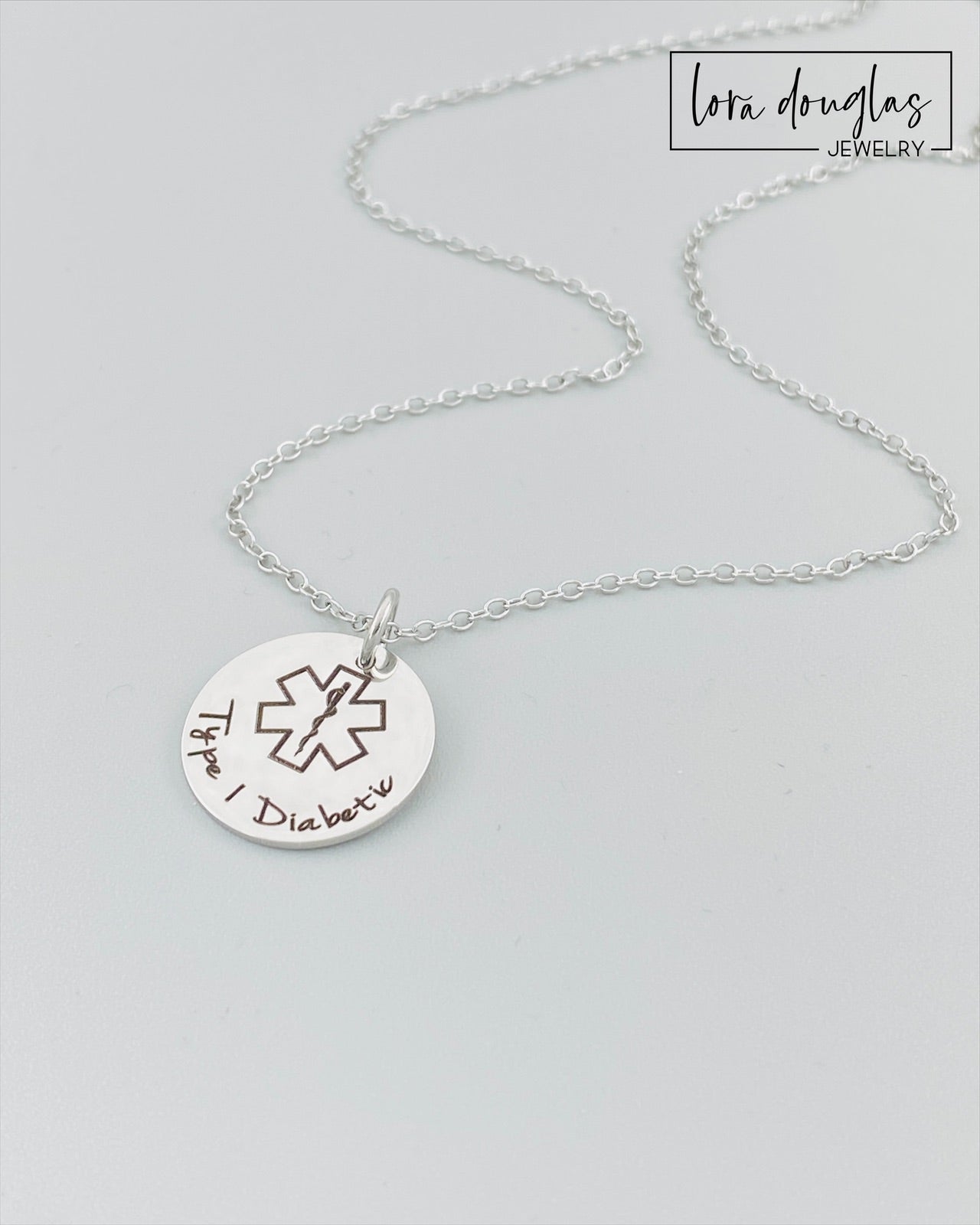 custom engraved medical ID pendant necklace shown in silver stainless steel with engraved medical alert symbol and personalized health information, durable hypoallergenic medical alert necklace with minimalist style