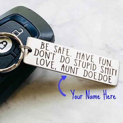 A personalized metal keychain with engraved text that reads 'BE SAFE HAVE FUN DON'T DO STUPID SHIT' accompanied by a space for custom text entry.