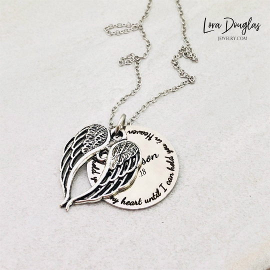 Two stainless steel memorial necklaces with swing lockets. One has a silver finish and the other has a gold tone. Angel wing charm necklace.
