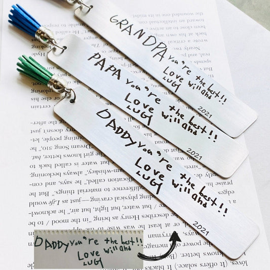 Preserve your child’s unique handwriting forever with this personalized handwriting bookmark. Expertly engraved, it transforms your child’s writing into a meaningful keepsake, perfect for parents and grandparents. A heartfelt gift for moms, dads, and grandparents, it adds a personal touch to every reading moment while celebrating the special bond in a timeless way.
