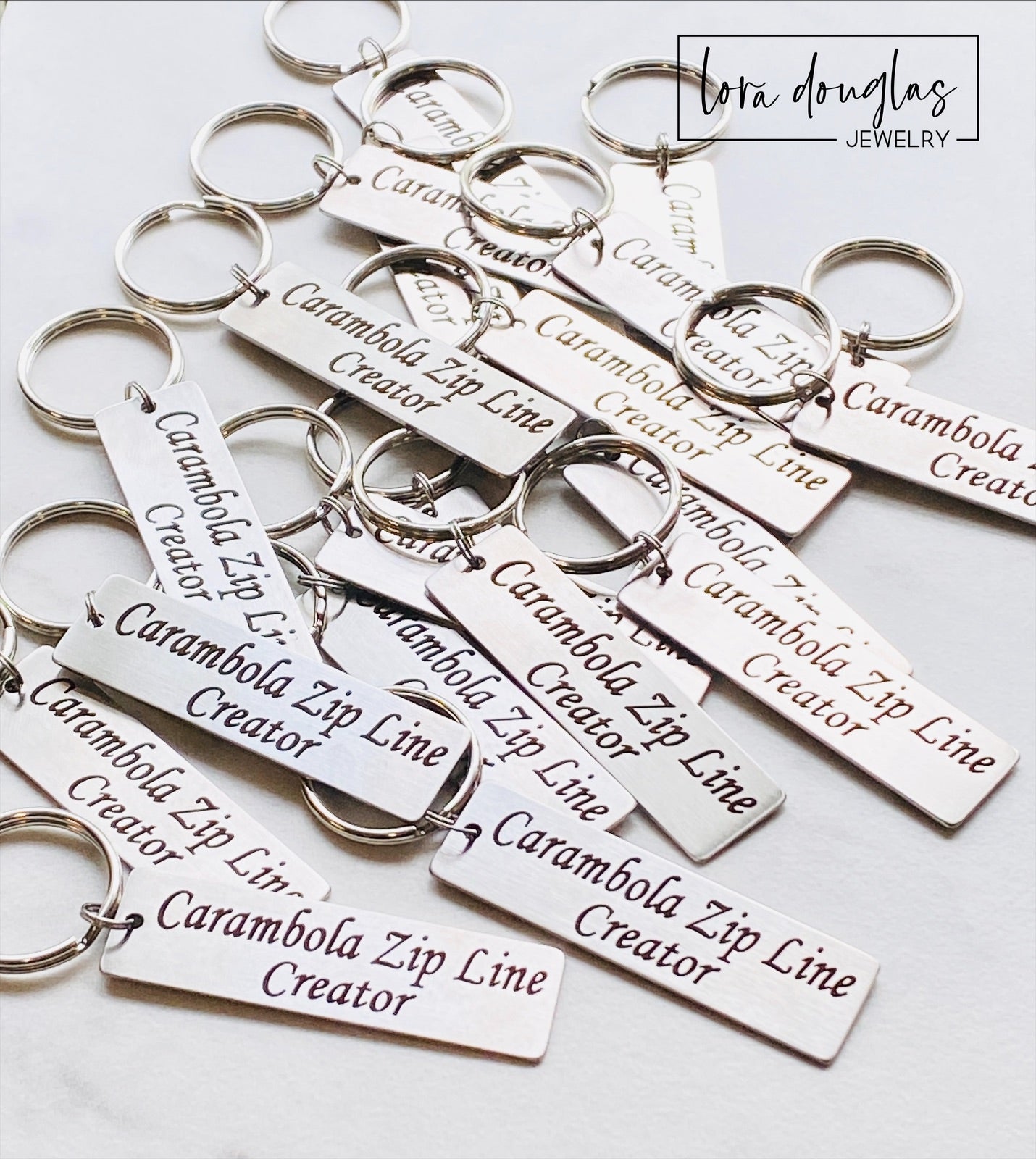 A stainless steel keychain with a laser engraved personalized message. The keychain has a rectangular tag with an example of custom text that can be added, indicating it is a personalized product.