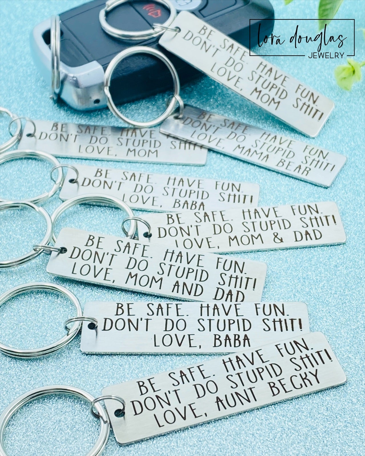 A personalized metal keychain with engraved text that reads 'BE SAFE HAVE FUN DON'T DO STUPID SHIT' accompanied by a space for custom text entry.