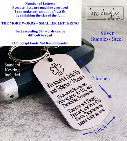 A stainless steel medical alert keychain displayed on a key. The tag has sample text for customization and indicates that additional text can be added on the back.