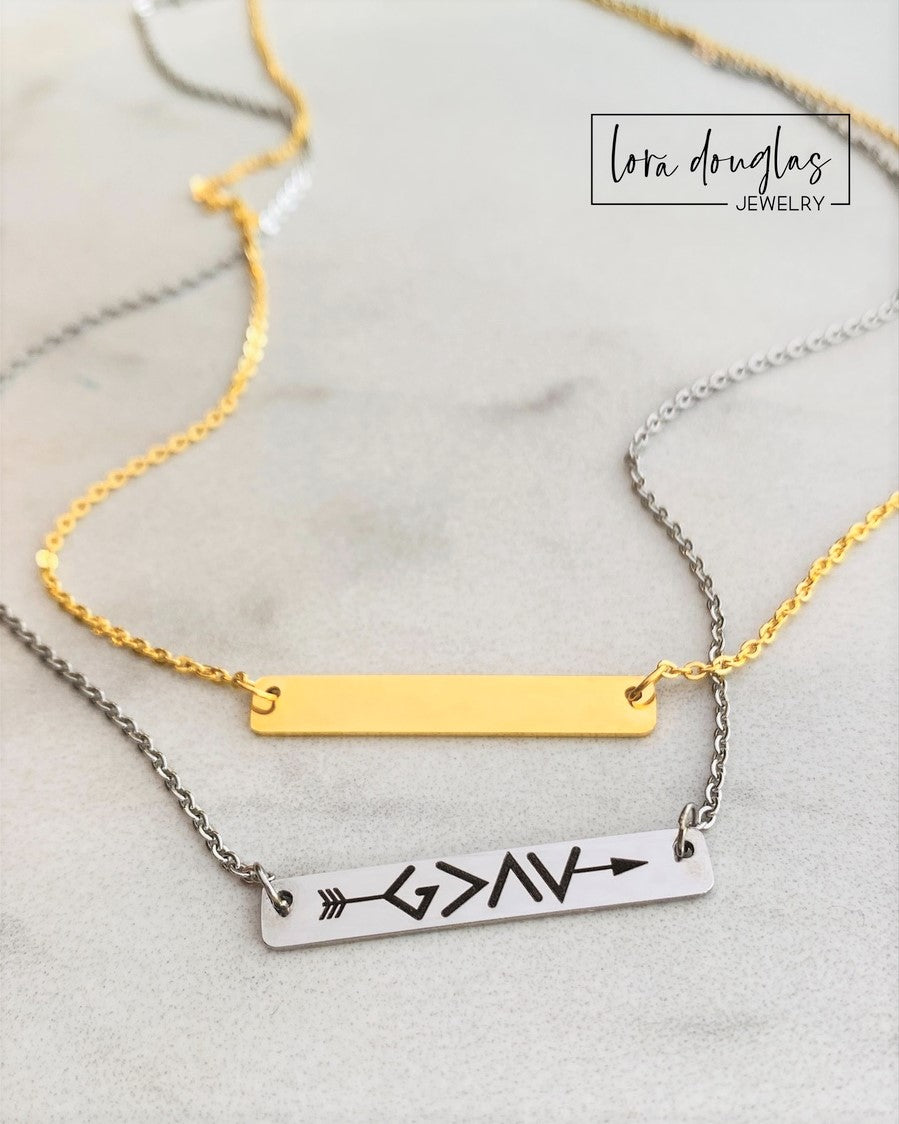 God Is Greater Than The Highs and Lows  bar necklace. Featuring a clever symbol design. Gold or silver bar necklace