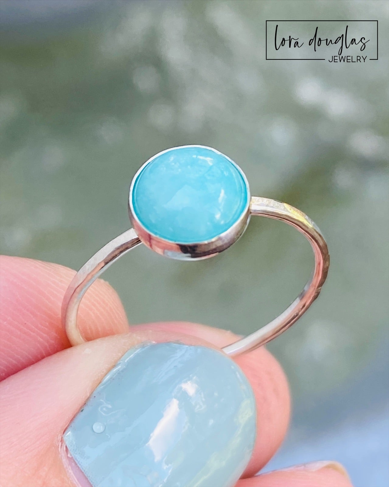 A sterling silver ring with a blue amazonite stone, set in a classic bezel setting.