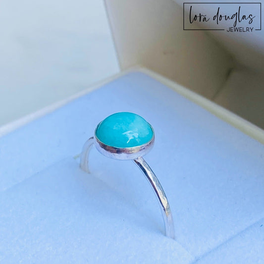 A sterling silver ring with a blue amazonite stone, set in a classic bezel setting.
