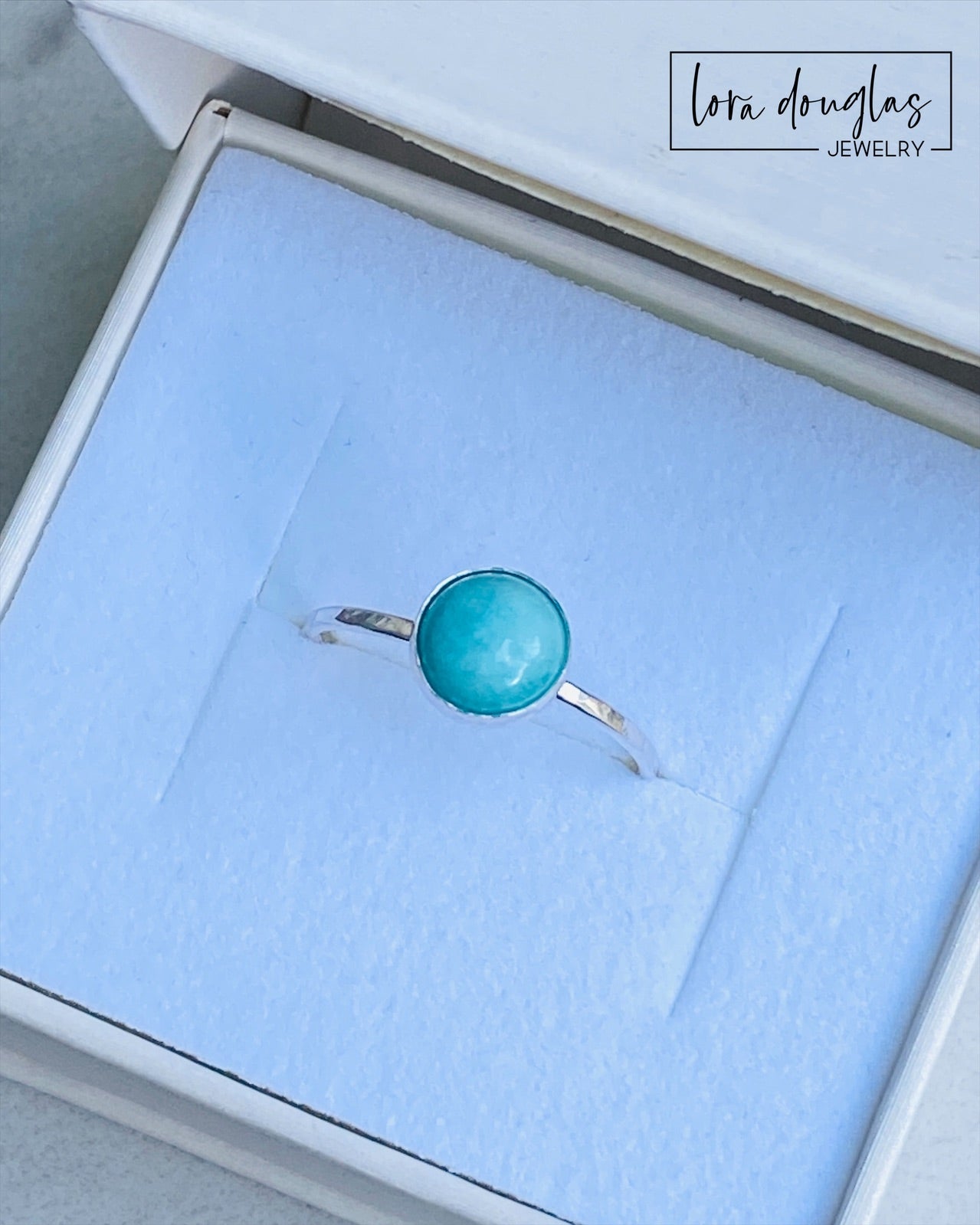 A sterling silver ring with a blue amazonite stone, set in a classic bezel setting.
