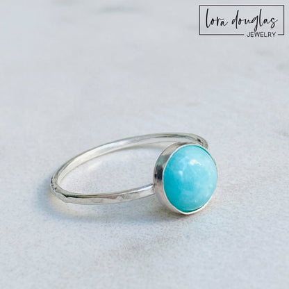A sterling silver ring with a blue amazonite stone, set in a classic bezel setting.